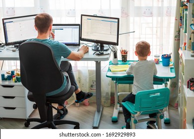 Father With Kid Trying To Work From Home During Quarantine. Stay At Home, Work From Home Concept During Coronavirus Pandemic