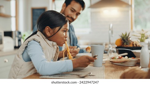 Father, kids and a girl eating spaghetti with her family in the dining room of their home together for supper. Food, children and parents around a table for a meal, bonding over dinner in a house - Powered by Shutterstock