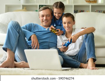 Father With Kids Playing Computer Games 