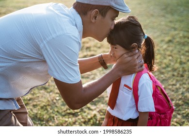 Father Kiss Her Daughter Forehead When Taking Her To School In The Morning. Primary Student First Day