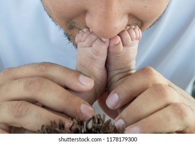 Father Kissing Baby Feet