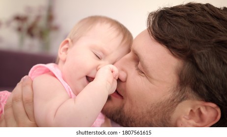 Father Kissing Daughter In Pink Dress. Happy Father Day. Dad Kiss Baby. Man Playing With Child. Happy Father Kissing Baby. Close Up Of Joyful Dad Play With Kid. Dad Love Baby. Male Tenderess Concept