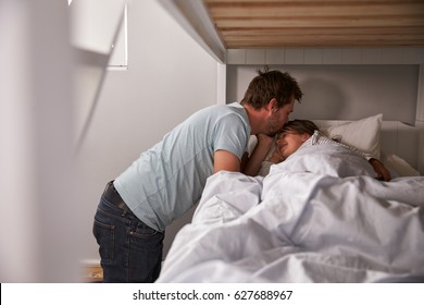 Father Kissing Goodnight To Daughter At Bedtime - Powered by Shutterstock