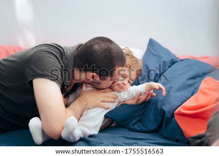Similar – Image, Stock Photo Man reading with wife and son sleeping