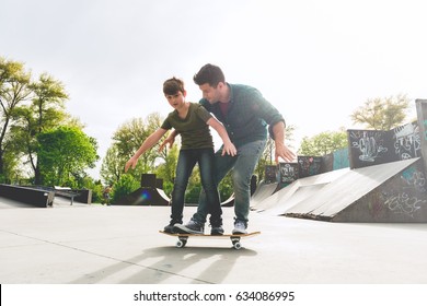 Father Learning His Son To Skate