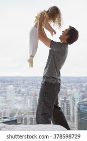 Father Lifting His Daughter