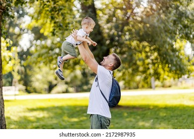 A father lifting his little boy in the air and playing with him in nature. - Powered by Shutterstock