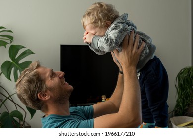 Father Lifting His Son Laughing Inside His House.