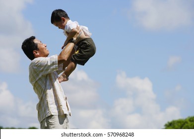 Father Lifting Son In The Air, Side View