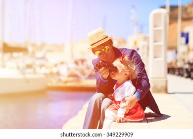 father and little daughter looking at binoculars in the port, family travel - Powered by Shutterstock