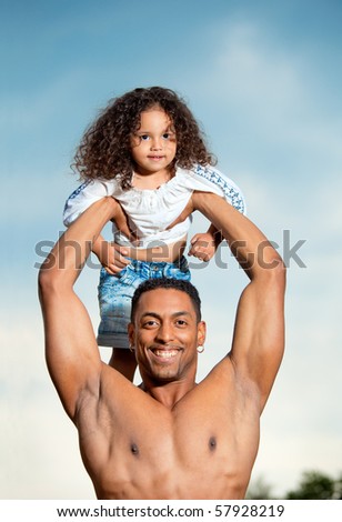 Father with little daughter playing in park