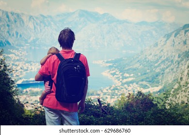 father with little daughter travel hiking in mountains