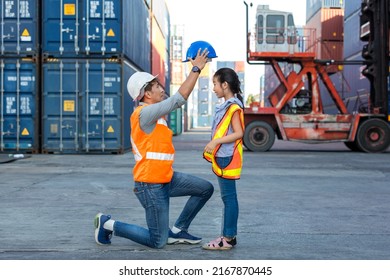 Father and little daughter wearing a safety helmet at Container cargo site. Business heir concept. Happy father and daughter wearing safety helmet work site. Business heir concept. - Shutterstock ID 2167870445