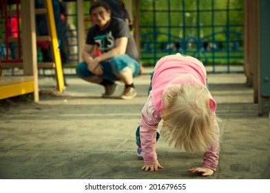 Father Looking How Baby Getting Up