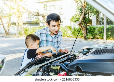 Father Looks At Innocent Son Pointing At Family Car Diesel Engine With Happiness And Smile : Cute Little Asian Father And Son Check The Engines Of Their Pick-up Trucks Before The Trip.