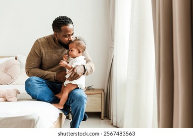 A father lovingly interacts with his baby in a cozy room, highlighting their strong bond and the warmth of family moments. Happy diversity family concept. - Powered by Shutterstock