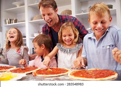 Father Making Pizza With His Kids