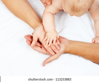 Father Mother And Baby Holding Hands Family