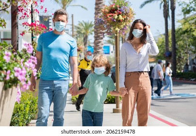 Father Mother And Child In Protective Masks. Family During The Coronavirus Pandemic.