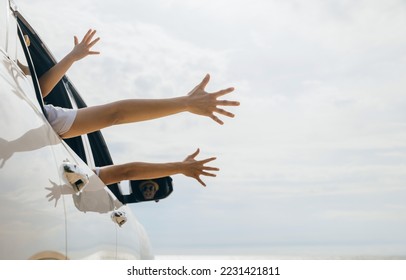 Father, mother and children raise hand wave goodbye, People having fun on road trip, vacation holiday, Happy family sitting in car waving hands travel outside car windows going to beach for travel