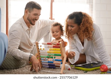 Father and mother with daughter play wooden toy colorful bead abacus. Learning and Play together happy time with family. - Powered by Shutterstock