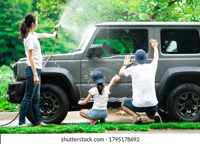 Father, Mother And Daughter Wash The Car