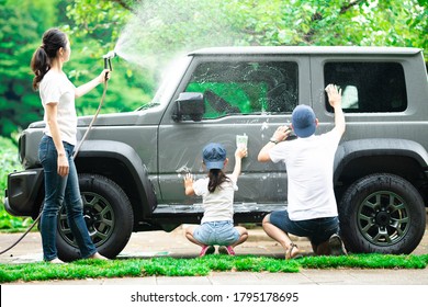 Father, mother and daughter wash the car - Powered by Shutterstock