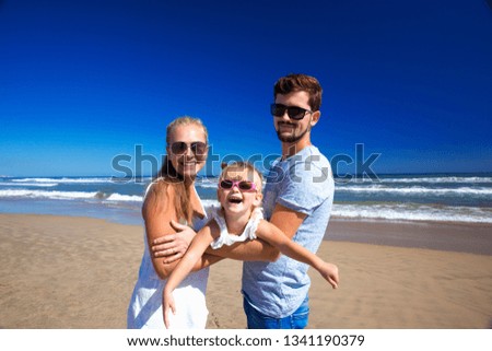 Father mother and little baby have fun on the family vacation.