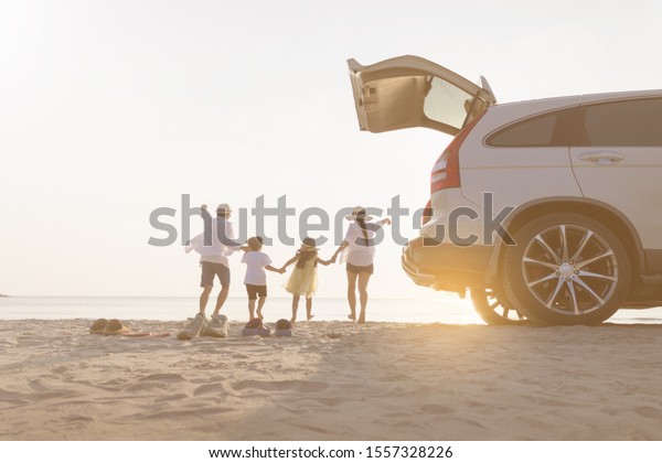 Father,\
mother, son and daughter, relaxing on the\
beach.