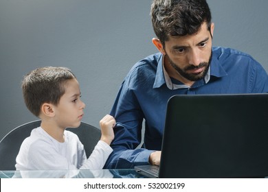 Father on laptop ignoring son while the child tries to catch his attention.
