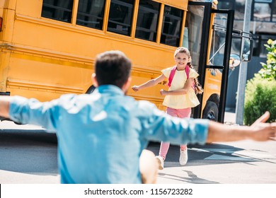 Father With Open Arms Waiting For Daughter While She Running From School Bus