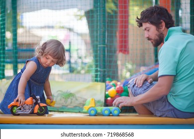 Father Play With His Toddler Daughter In Boys Games. Two Color Cars. Family Leisure. Loving Caring Single Father. Kid Playing With Parent.