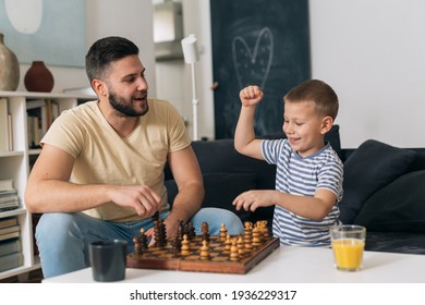 father playing chess with his son at home - Shutterstock ID 1936229317