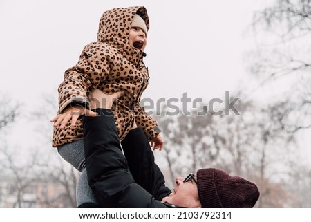 Father playing with child outdoors. Happy parenting, family bond. Toddler preschool girl daughter with father lifting up