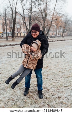 Father playing with child outdoors. Happy parenting, family bond. Toddler preschool girl daughter with father lifting up