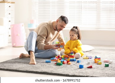 Father Playing With His Child At Home