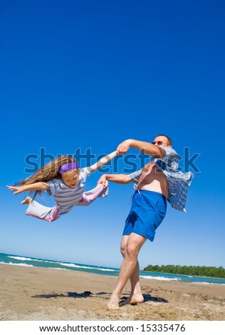 Similar – Image, Stock Photo Father and son playing superhero on the beach at the day time. People having fun outdoors. Concept of summer vacation and friendly family.