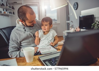 Father playing with his little son at home office - Powered by Shutterstock