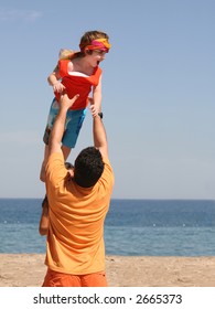 Father playing with his son on the beach