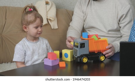 Father Plays With His Little Daughter In Toy Cubes And A Toy Car, The Child Has Fun Indoors With Dad, Color Activities For Kid Autists, Baby Development From An Early Age, Grandfather And