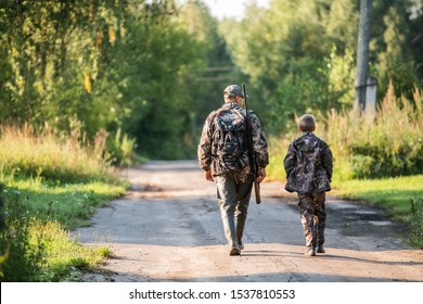 Father Pointing And Guiding Son On First Deer Hunt