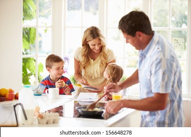 Father Preparing Family Breakfast In Kitchen - Powered by Shutterstock