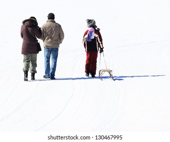 Father Pulling Children On Sledge Through Winter Landscape - Powered by Shutterstock