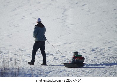 Father Pulls Child On Sled Across Stock Photo 2125777454 | Shutterstock