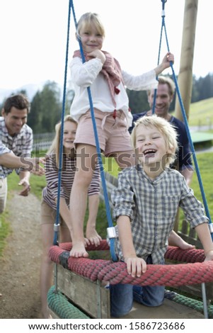 Similar – old swing on the playground on the street