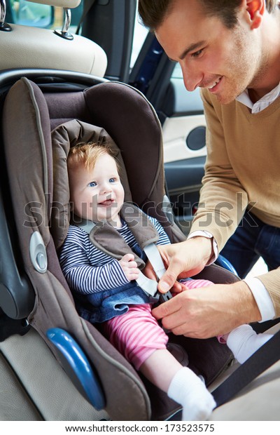 Father Putting Baby Into Car\
Seat