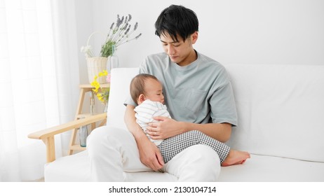 A Father Putting His Baby To Sleep.