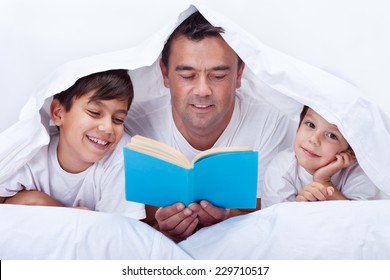 Father Reading A Story To His Little Sons - Family Time Together