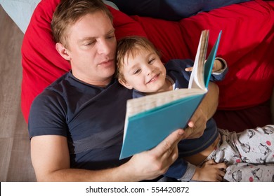 Father reading a story to his little son. happy family time together at home.

 - Powered by Shutterstock