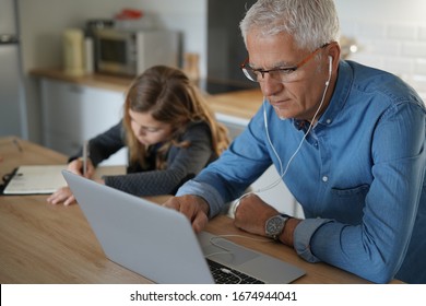 Father and school-girl working form home, telework and e-learning - Powered by Shutterstock